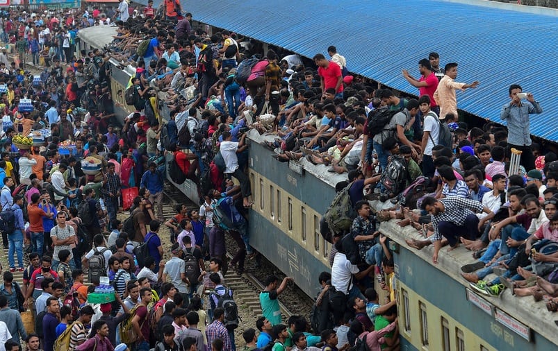 Bangladeshi Muslims storm overcrowded trains to get home for holiday